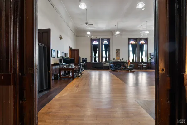 a living room with furniture fireplace and a window