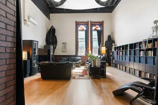 a view of a livingroom with furniture and gym equipment