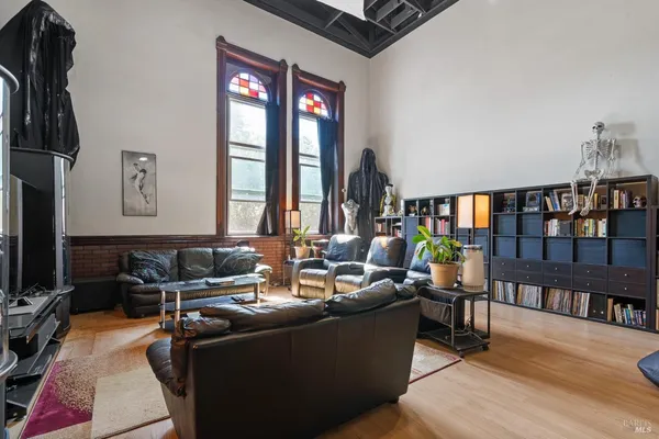 a view of hallway with furniture and wooden floor