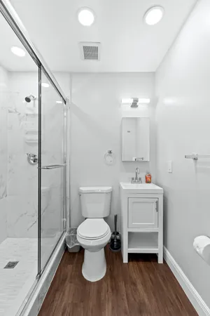 a bathroom with a toilet sink and a mirror