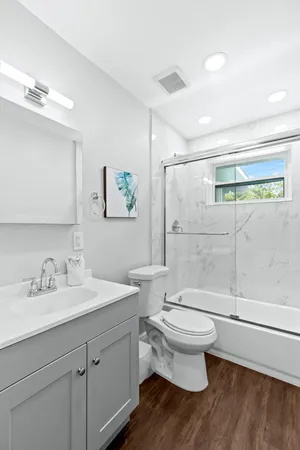 a bathroom with a sink toilet and shower