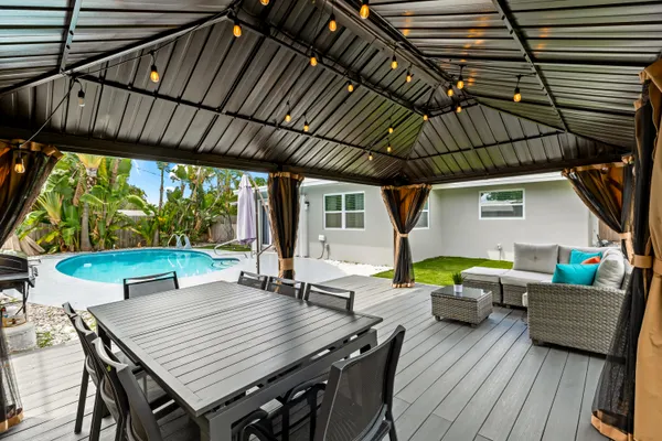 a view of a backyard with chairs and a small pool