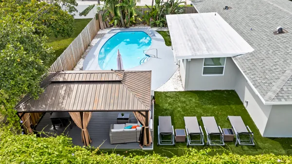 an aerial view of a house with a yard basket ball court and outdoor seating