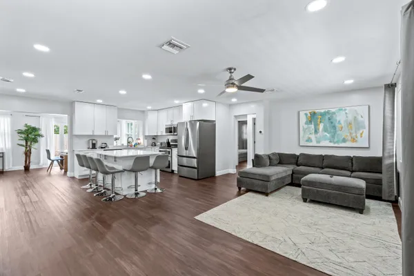 a living room with furniture and kitchen view