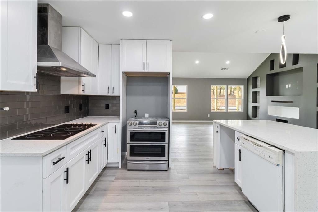 292 Natchez Circle Winder, GA 30680 - Photo 11 of 29 a kitchen with stainless steel appliances a stove sink microwave and cabinets