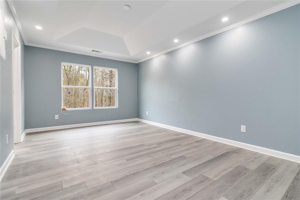 292 Natchez Circle Winder, GA 30680 - Photo 19 of 29 an empty room with wooden floor and windows