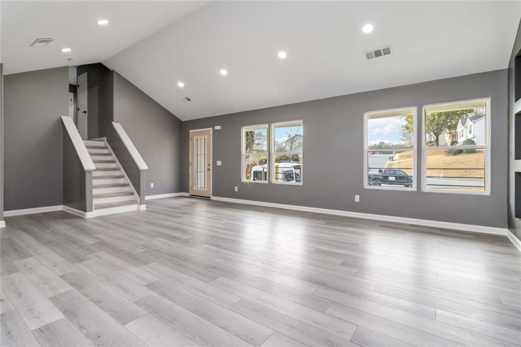 292 Natchez Circle Winder, GA 30680 - Photo 2 of 29 an empty room with wooden floor and windows
