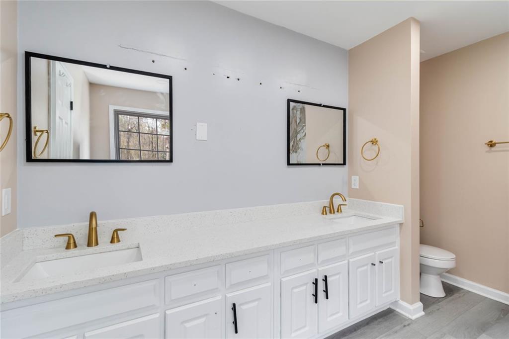 292 Natchez Circle Winder, GA 30680 - Photo 21 of 29 a bathroom with a double vanity sink and a toilet