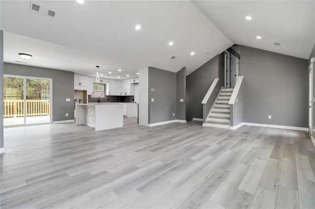 a view of a kitchen with a sink and a refrigerator