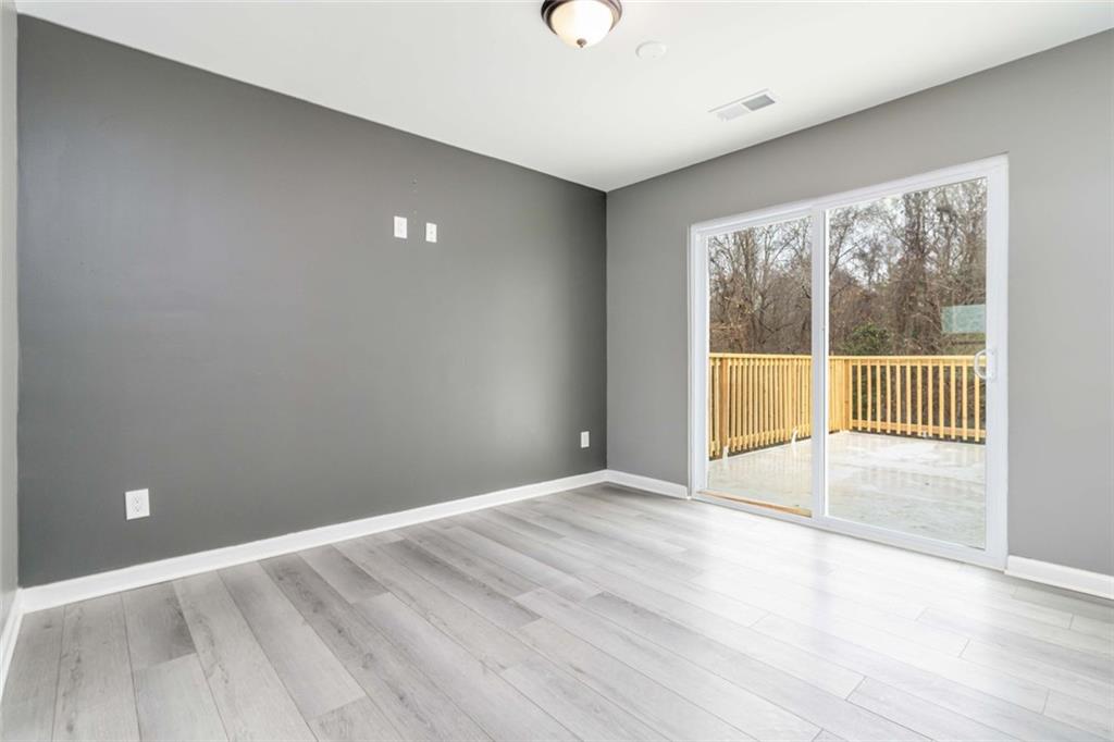 292 Natchez Circle Winder, GA 30680 - Photo 9 of 29 wooden floor in an empty room with a window
