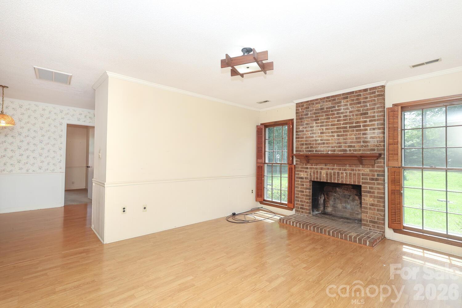 2000 Lawton Bluff Road Charlotte, NC 28226 - Photo 15 of 40 a view of empty room with fireplace and wooden floor