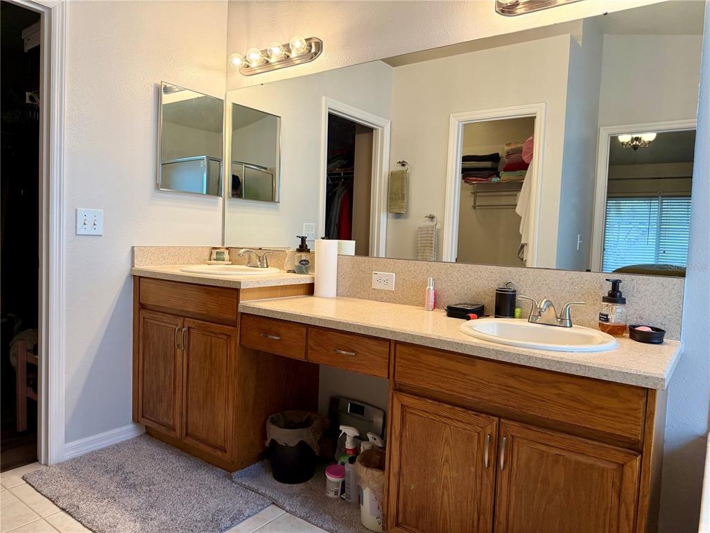 4303 Orange Ridge Court Valrico, FL 33596 - Photo 30 of 40 a bathroom with a double vanity sink and a mirror