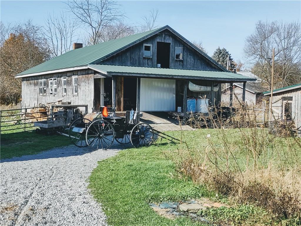 3325 Kennard Road Atlantic, PA 16111 - Photo 10 of 12 a front view of house with yard and outdoor seating