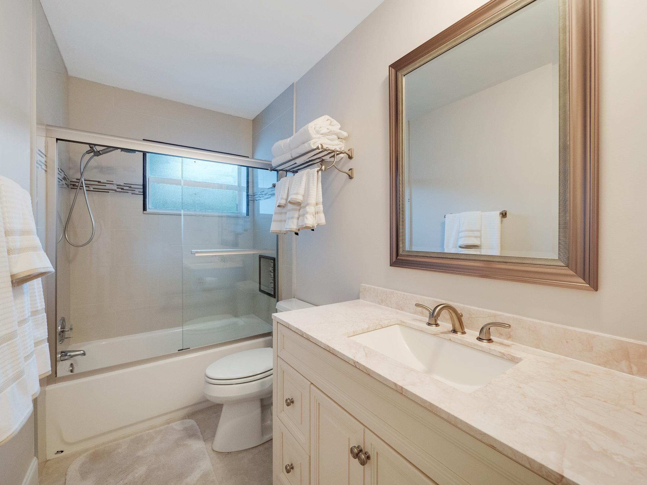 625 Atlantic Road North Palm Beach, FL 33408 - Photo 13 of 28 a bathroom with a granite countertop sink toilet and shower
