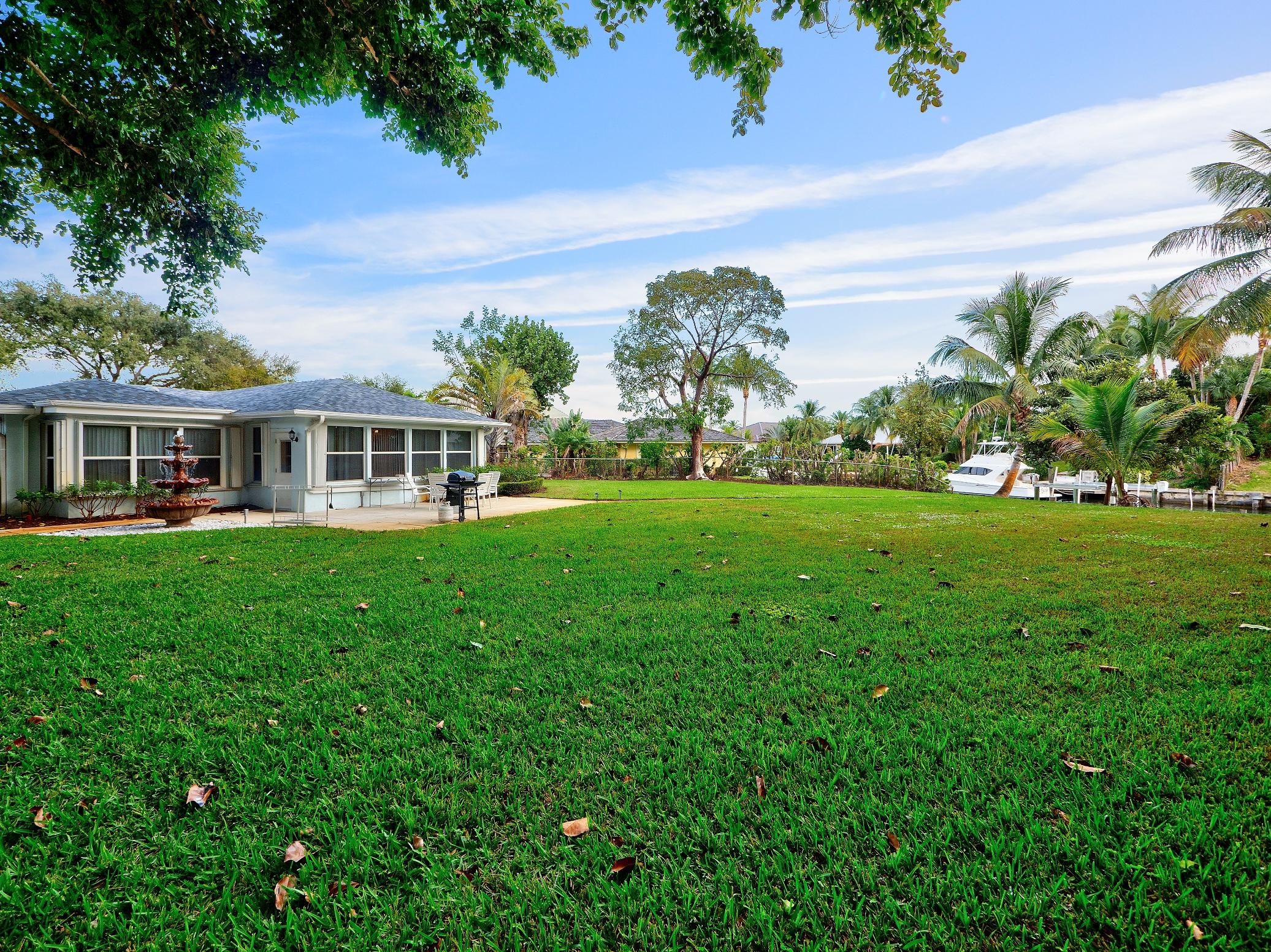 625 Atlantic Road North Palm Beach, FL 33408 - Photo 2 of 28 a view of a house with a yard and potted plants