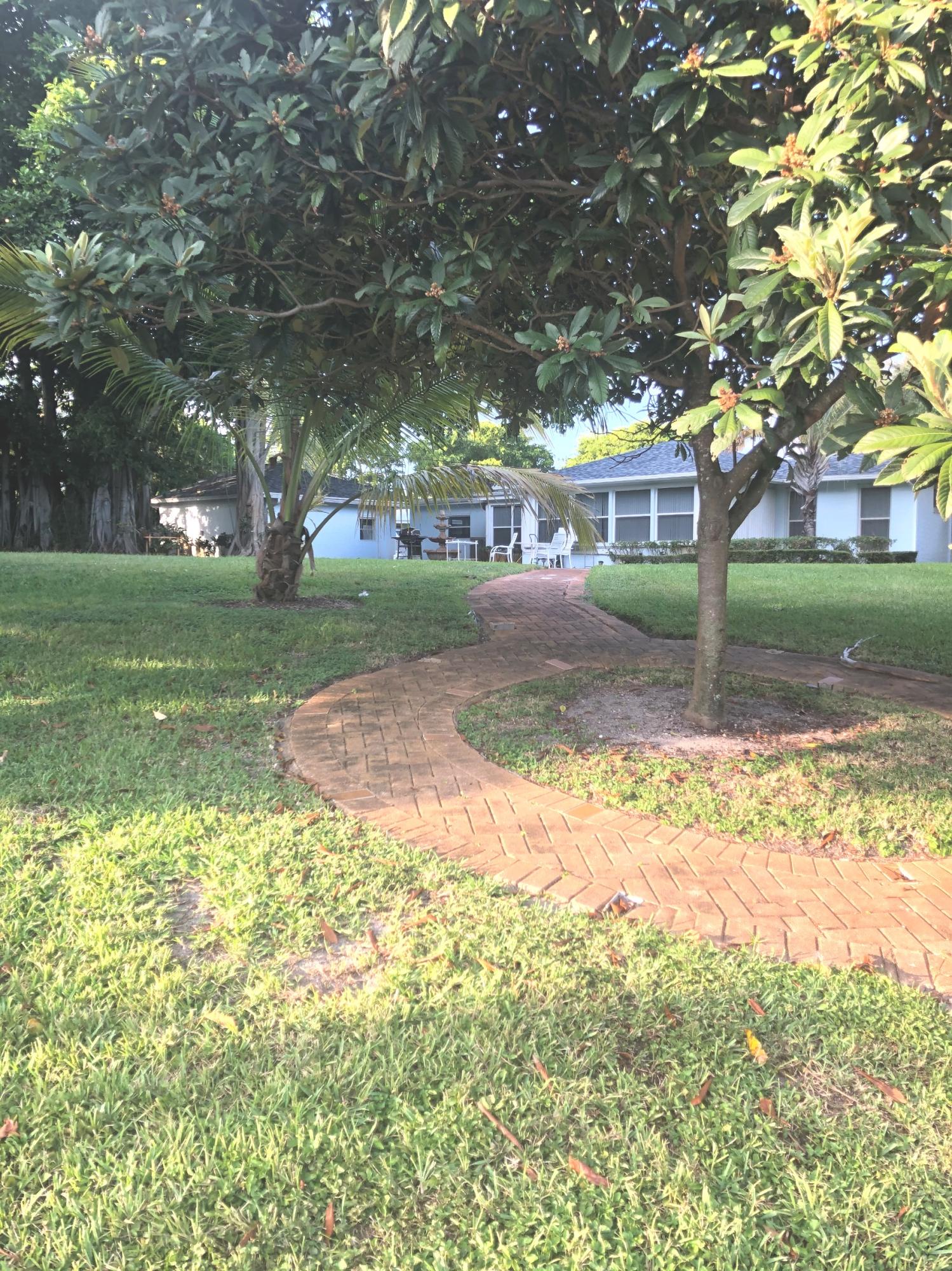 625 Atlantic Road North Palm Beach, FL 33408 - Photo 21 of 28 a view of a yard with a house and a large tree