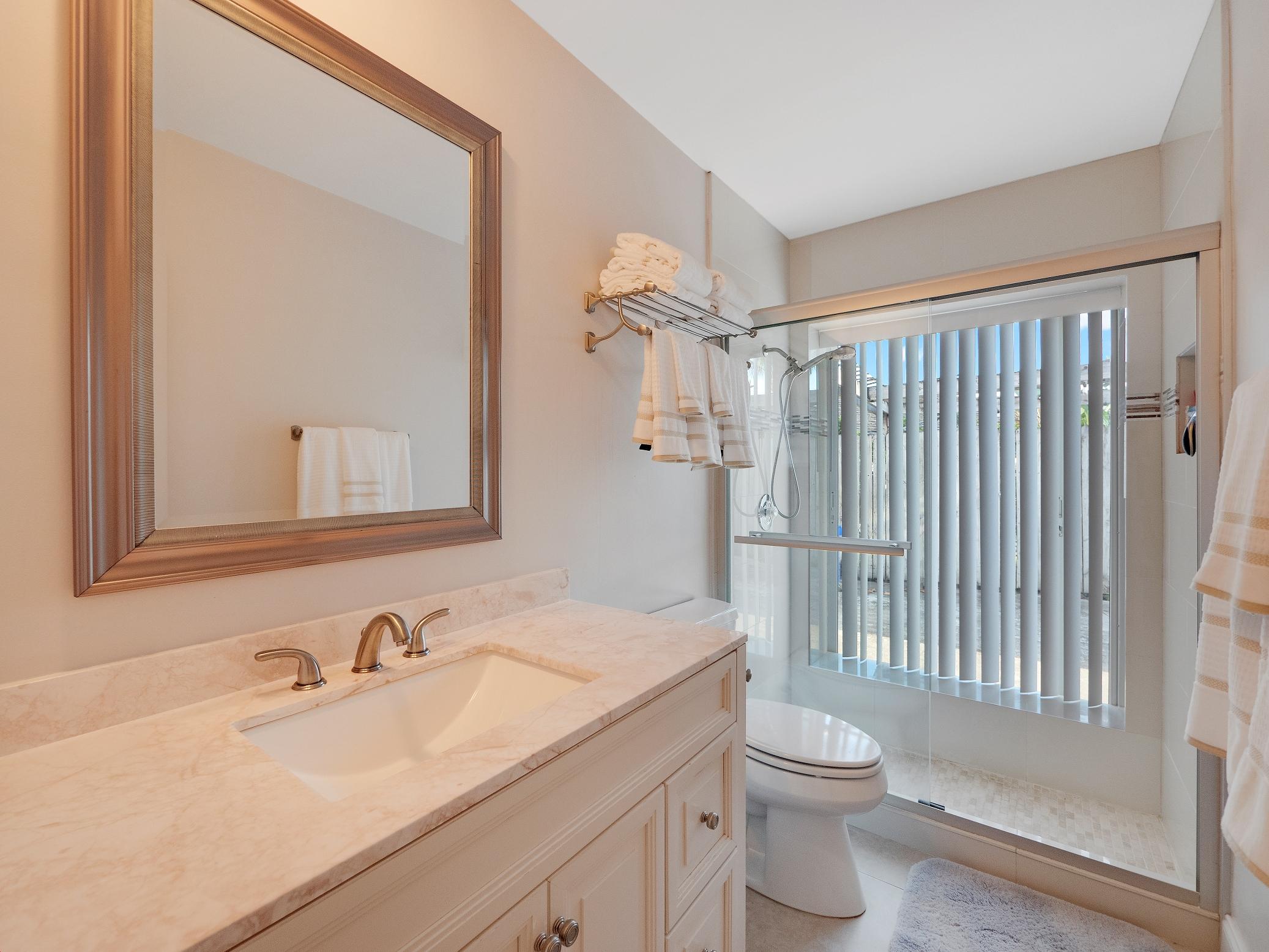 625 Atlantic Road North Palm Beach, FL 33408 - Photo 9 of 28 a bathroom with a sink toilet and shower