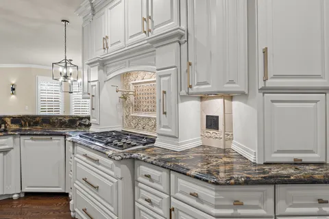 a kitchen with stainless steel appliances a stove a sink dishwasher a refrigerator and a oven with wooden floor