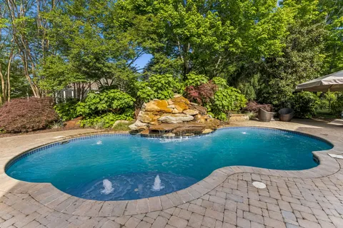 a view of a swimming pool in a backyard