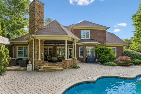 a view of a house with swimming pool and sitting area
