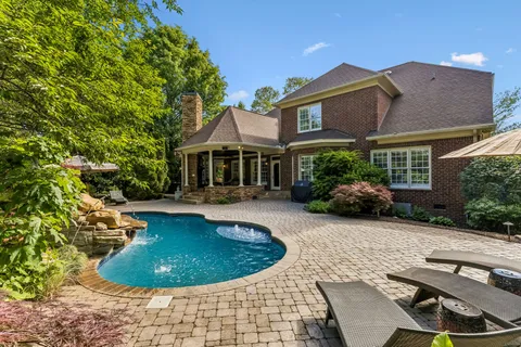 a backyard of a house with table and chairs