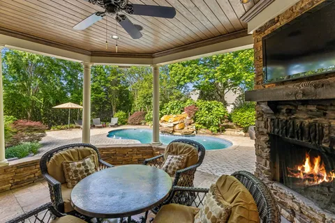 a dining room with patio furniture and garden view