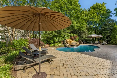 a view of backyard with plants and outdoor seating