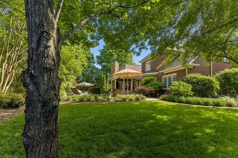 a backyard of a house with a garden and plants