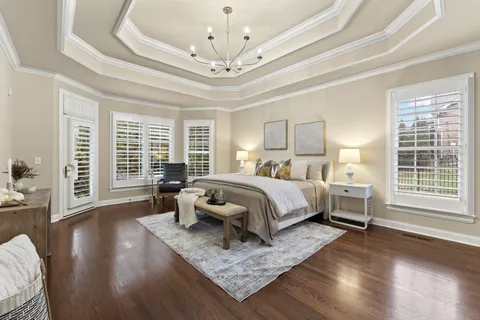 a bedroom with bed and wooden floor