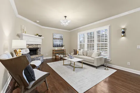 a living room with furniture fireplace and a window