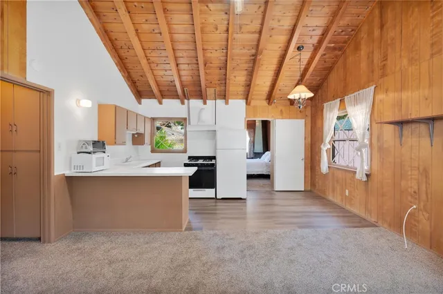 a view of a kitchen with refrigerator and a sink