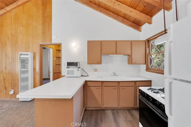 a kitchen with a sink a stove and cabinets