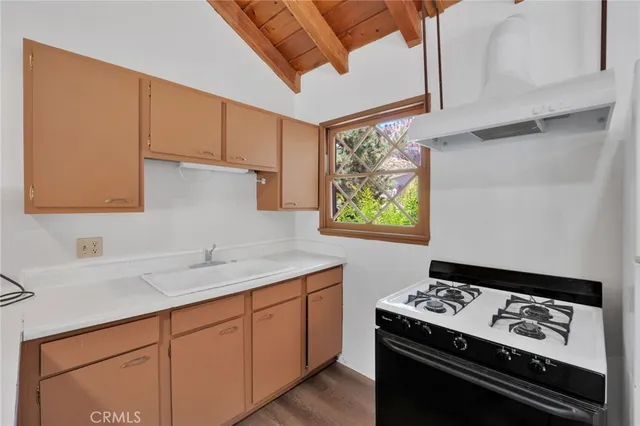 a kitchen with stainless steel appliances cabinets a window and a sink