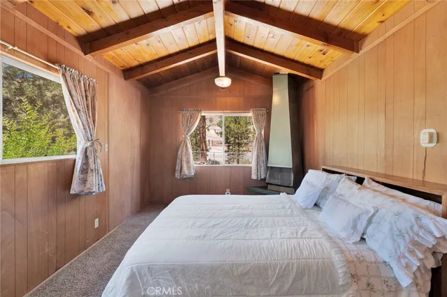 a spacious bedroom with a bed and a chandelier