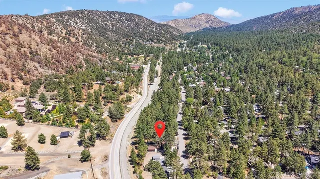 an aerial view of house with yard and outdoor seating