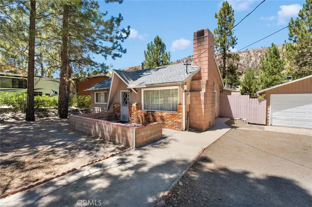 front view of a house with a yard and potted plants