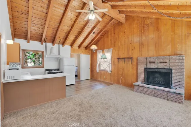 a view of a kitchen with a sink and a fireplace