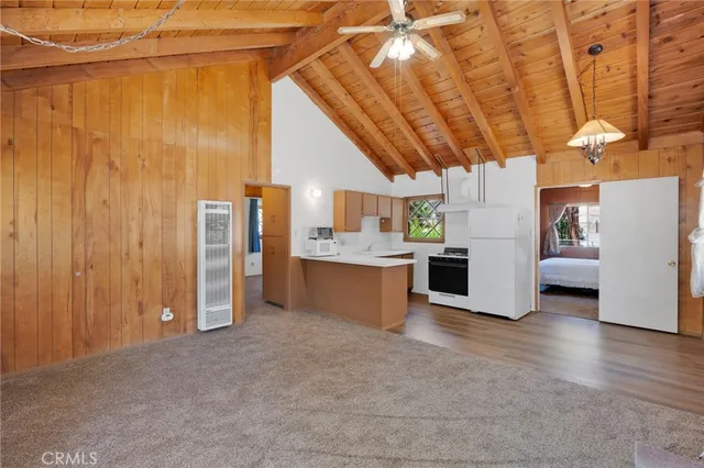 a view of a kitchen with refrigerator and a sink