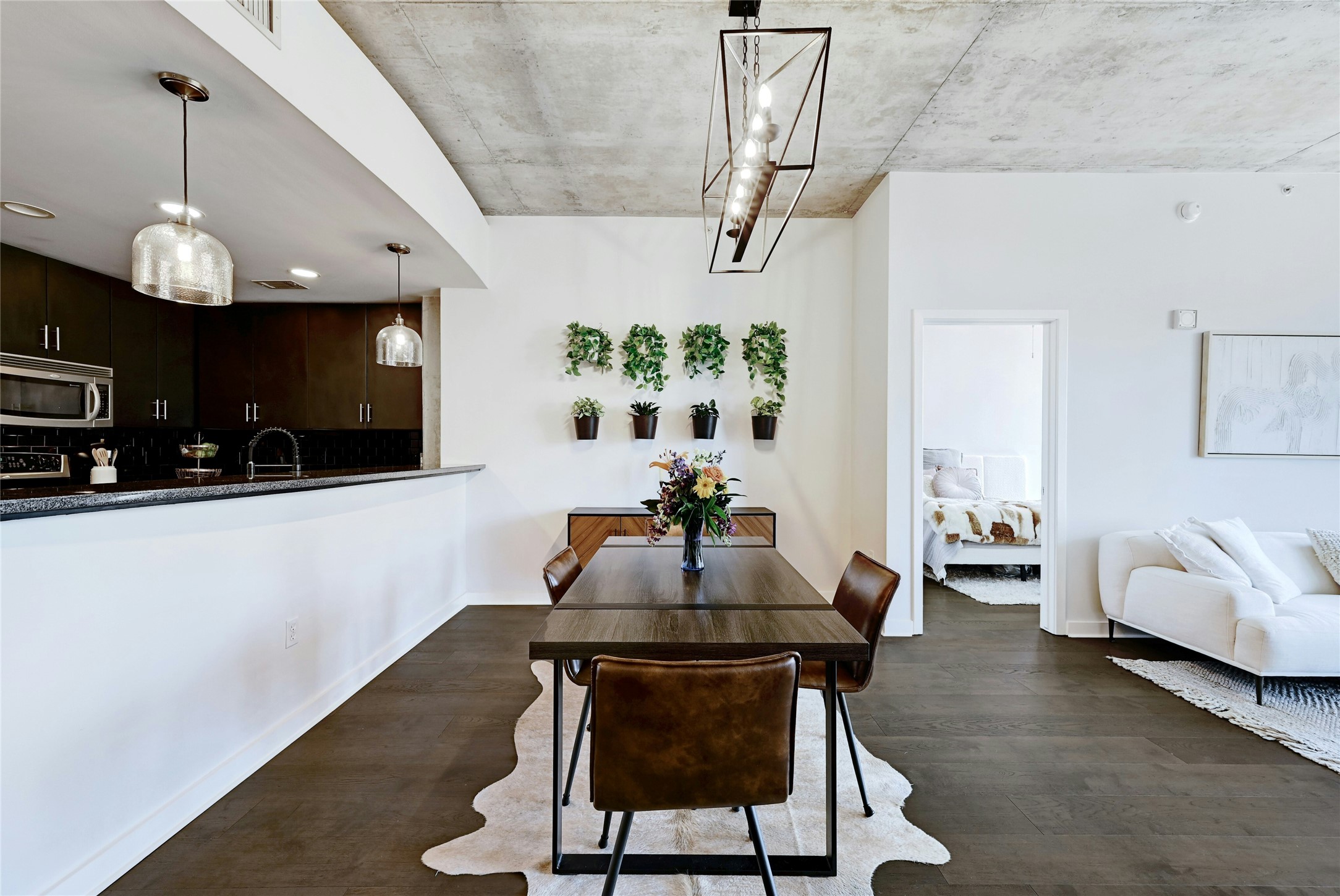 360 Nueces Street, Unit 1809 Austin, TX 78701 - Photo 5 of 25 Open-concept living area featuring wood-finish flooring and a concrete ceiling