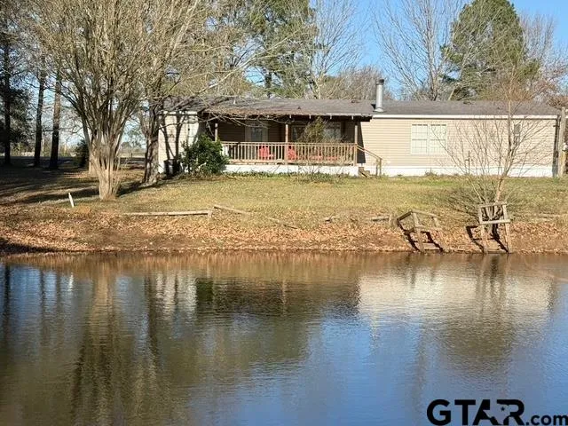 a view of a lake with a house swimming pool and outdoor space