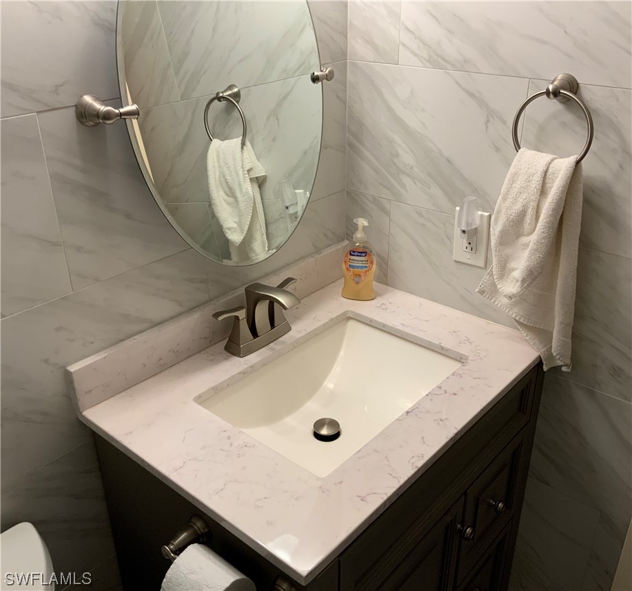 7055 New Post Road, Unit 5 North Fort Myers, FL 33917 - Photo 11 of 33 a bathroom with a sink and a mirror