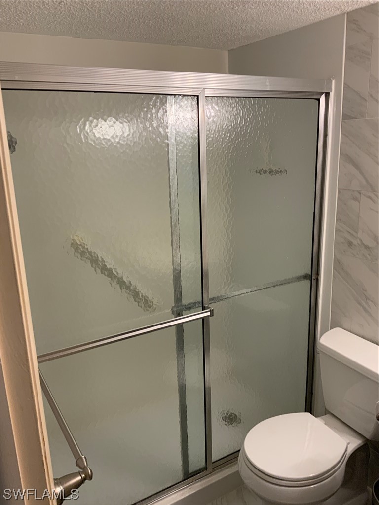 7055 New Post Road, Unit 5 North Fort Myers, FL 33917 - Photo 13 of 33 a white toilet sitting next to a shower