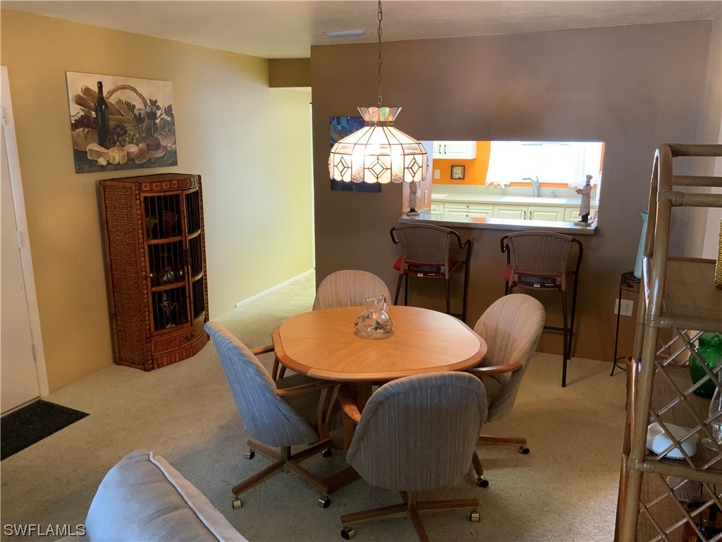 7055 New Post Road, Unit 5 North Fort Myers, FL 33917 - Photo 22 of 33 a dining room with furniture and window