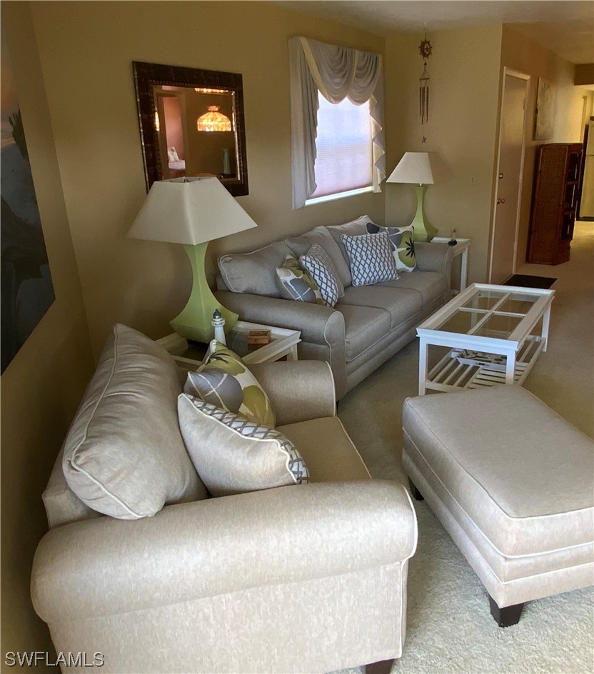 7055 New Post Road, Unit 5 North Fort Myers, FL 33917 - Photo 25 of 33 a living room with furniture and a mirror