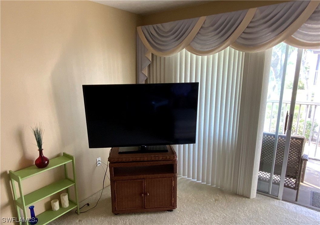7055 New Post Road, Unit 5 North Fort Myers, FL 33917 - Photo 27 of 33 a living room with furniture and a flat screen tv