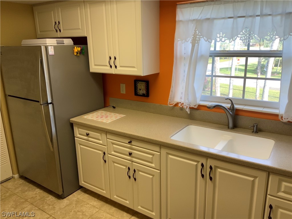 7055 New Post Road, Unit 5 North Fort Myers, FL 33917 - Photo 7 of 33 a kitchen with a refrigerator and a sink