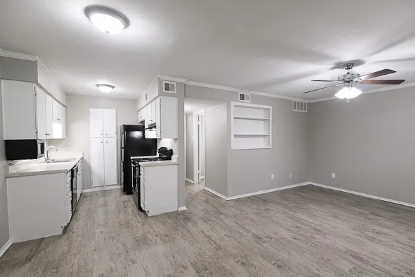 a kitchen with a refrigerator and a stove top oven