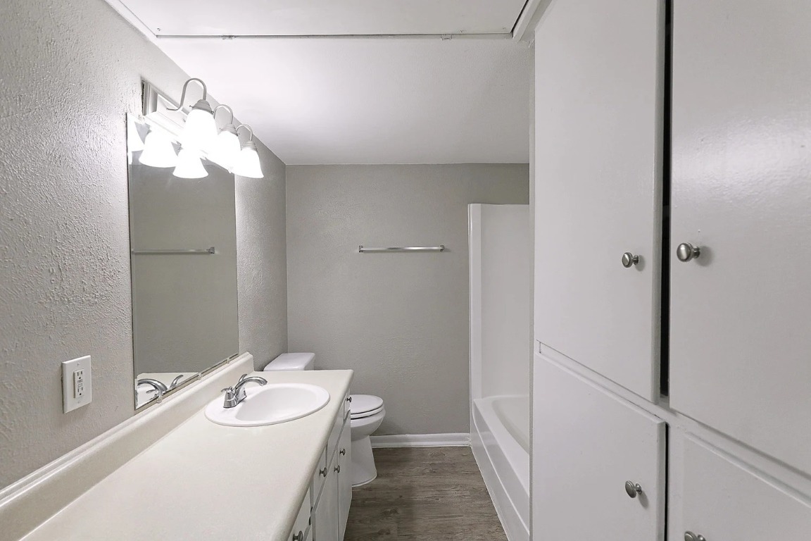 8100 North Mopac Expressway, Unit 2107 Austin, TX 78759 - Photo 16 of 23 Full bath featuring vanity, a textured wall, light wood-type flooring, and shower / washtub combination