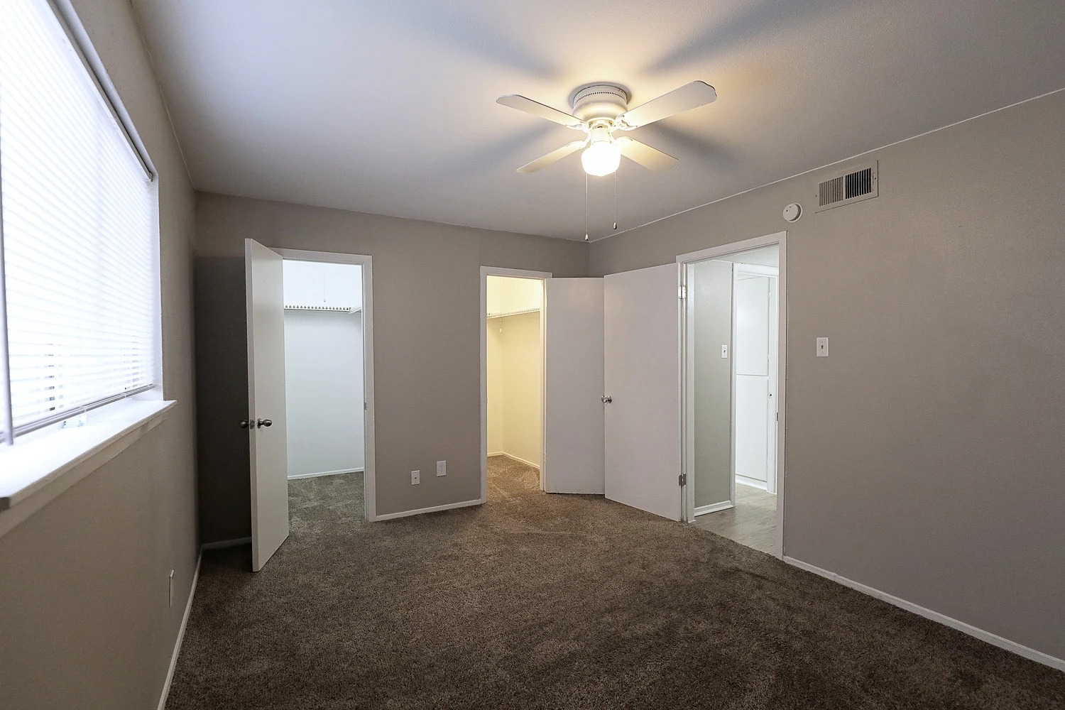 8100 North Mopac Expressway, Unit 2107 Austin, TX 78759 - Photo 20 of 23 Unfurnished bedroom with a walk in closet, dark colored carpet, and a ceiling fan