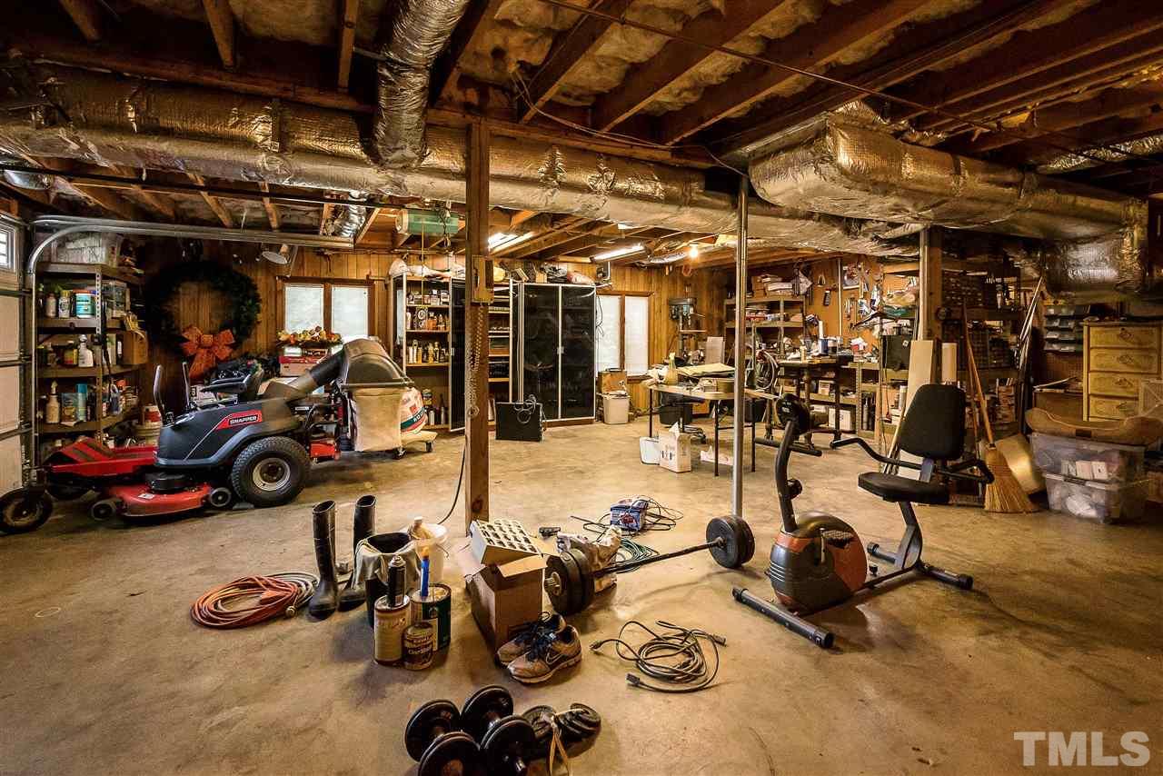 5 Chippers Way Durham, NC 27705 - Photo 24 of 25 1 car garage & plenty of storage/workshop area...lots of built in shelves & workbench that will convey.